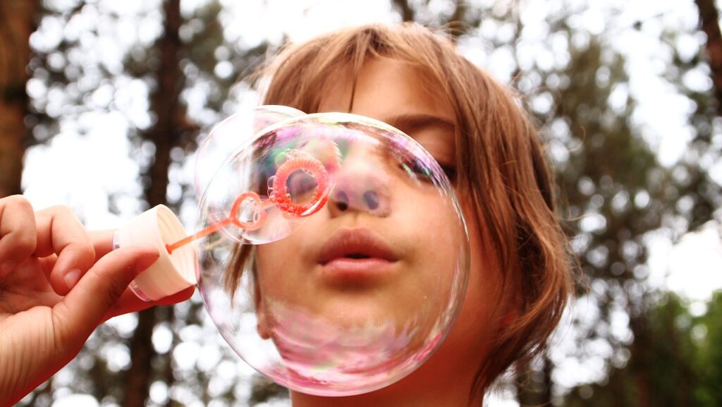 Child blowing soap bubbles